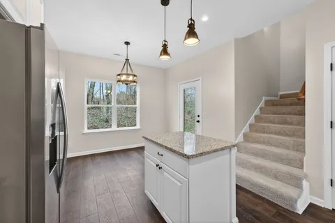 a view of an entryway with wooden floor and cabinet