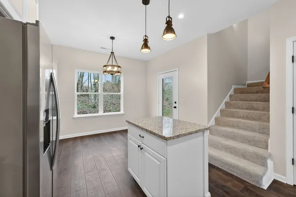 a view of an entryway with wooden floor and cabinet