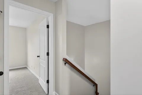a view of a hallway with stairs