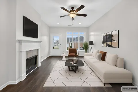 a living room with furniture a fireplace and a flat screen tv
