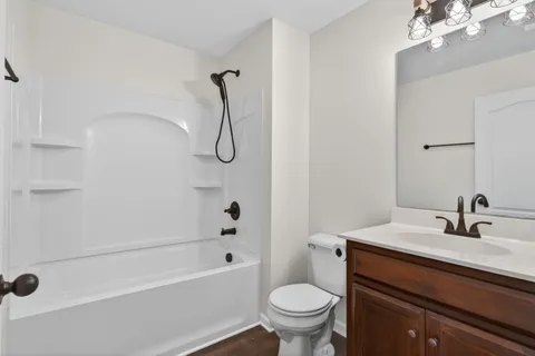 a bathroom with a sink a toilet and a bathtub