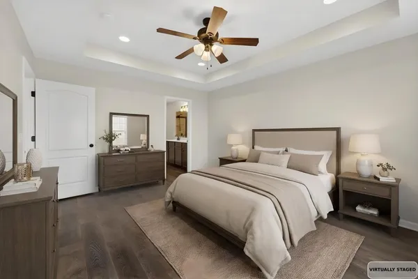 a bedroom with a bed a couches and a chandelier