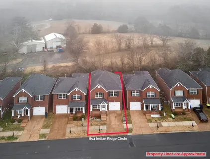 a view of multiple houses with a street