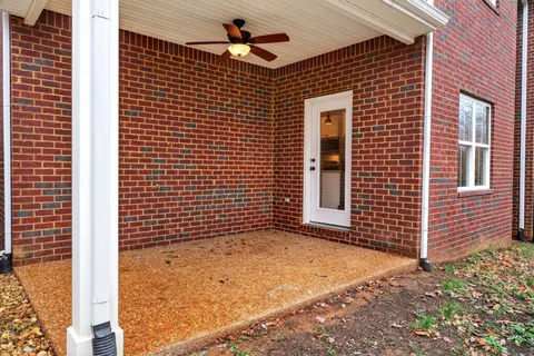 a view of a brick house with a large window