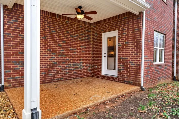 a view of a brick house with a large window