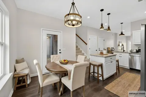 a very nice looking dining room with a table and chairs
