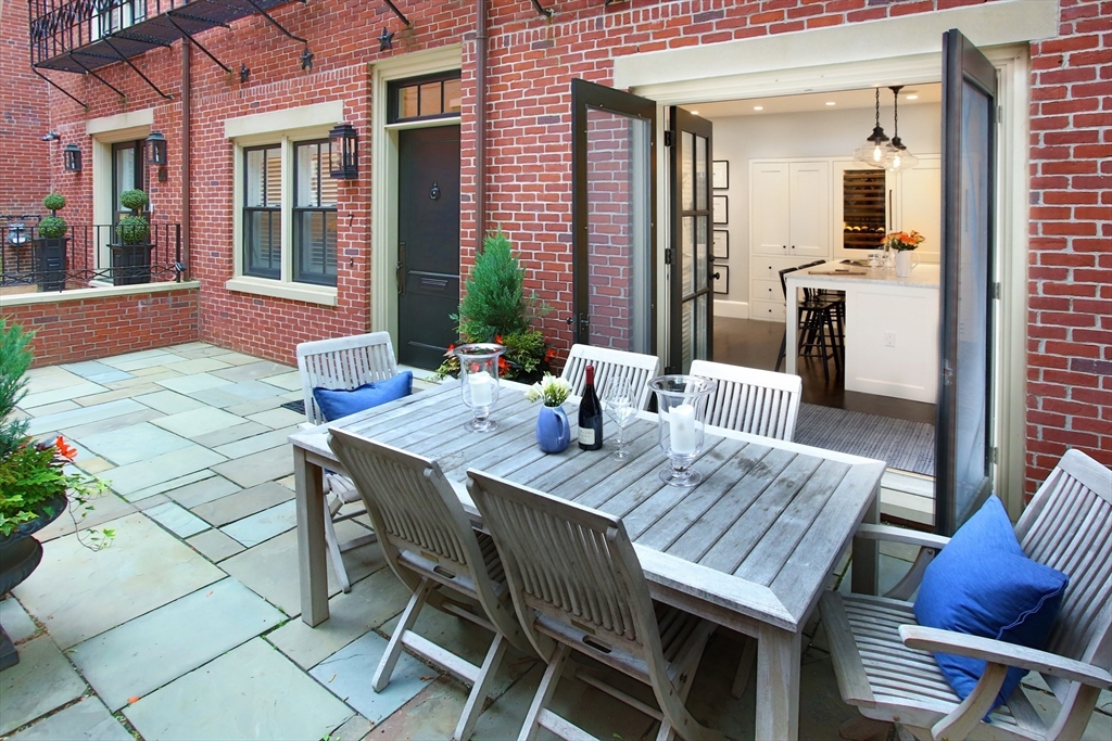 7 Spruce Court Boston, MA 02108 - Photo 1 of 25 a view of a dinning tables and chairs in a patio
