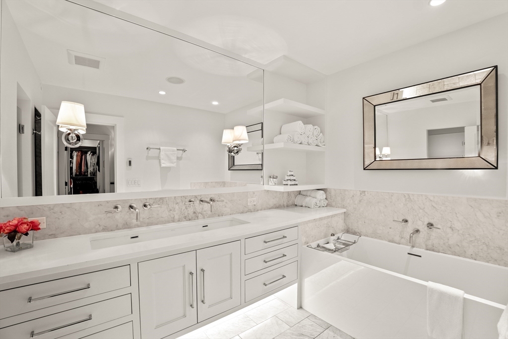 7 Spruce Court Boston, MA 02108 - Photo 14 of 25 a spacious bathroom with a sink double vanity granite tub shower and a mirror