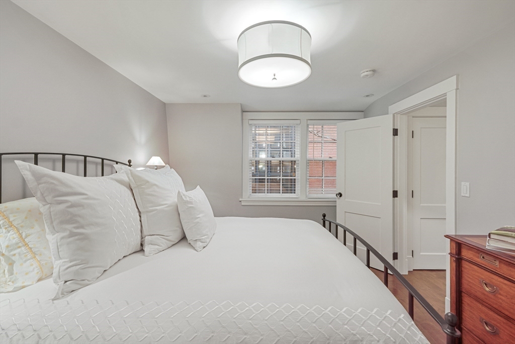 7 Spruce Court Boston, MA 02108 - Photo 17 of 25 a bedroom with a large bed and a chandelier