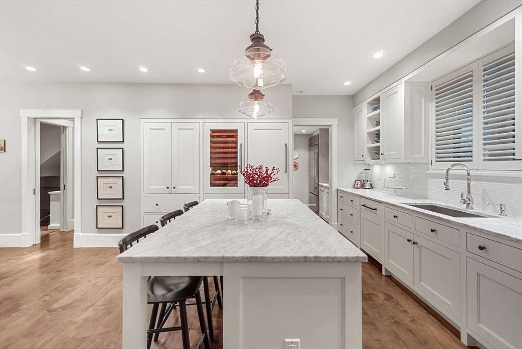 7 Spruce Court Boston, MA 02108 - Photo 7 of 25 a kitchen with center island table and chairs