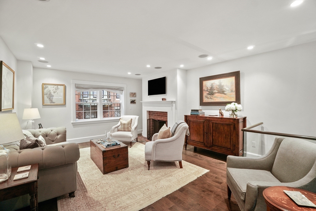 7 Spruce Court Boston, MA 02108 - Photo 8 of 25 a living room with furniture a fireplace and a flat screen tv