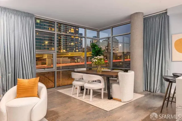 a living room with furniture kitchen view and a large window