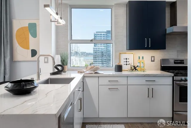 a kitchen with stainless steel appliances granite countertop a sink and a stove