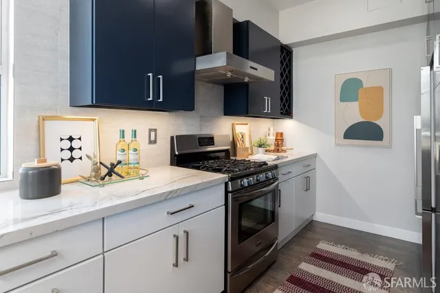 a kitchen with stainless steel appliances granite countertop a refrigerator and a stove