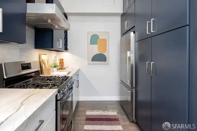 a kitchen with white cabinets and appliances