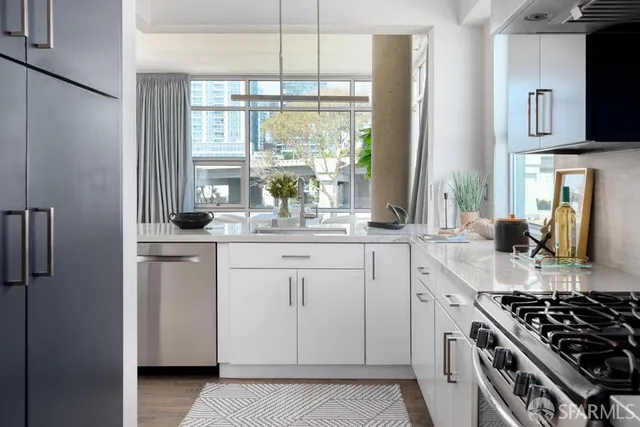 a room with kitchen island a sink stove and large mirror