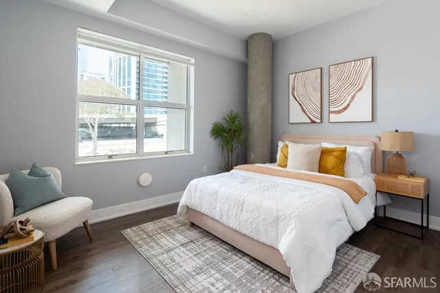 a bedroom with a bed and a window