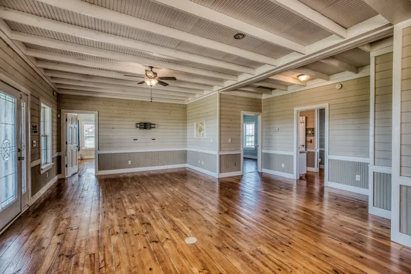 wooden floor in an empty room with a window