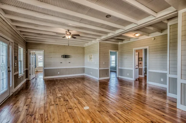 wooden floor in an empty room with a window