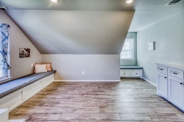 a view of a room with window and hardwood floor