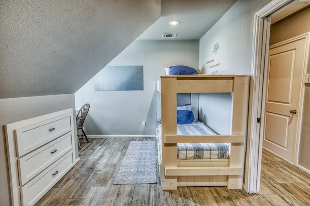 a view of room with wooden floor and cabinet