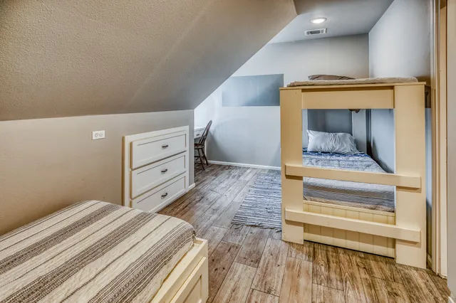 a bedroom with a bed and cabinets