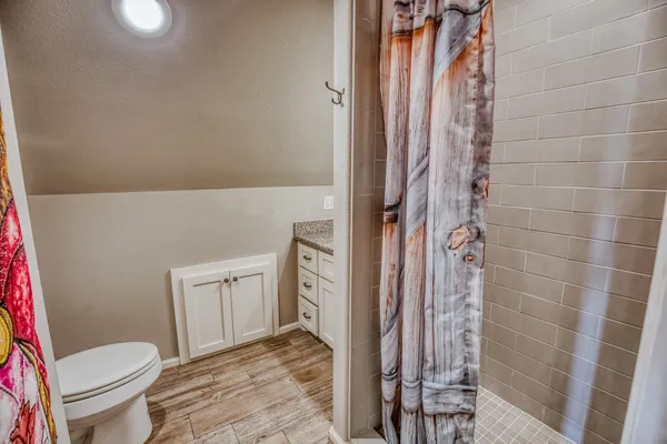 a bathroom with a toilet and a shower