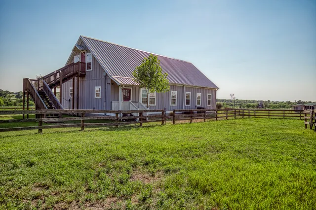 a front view of a house with a garden and deck