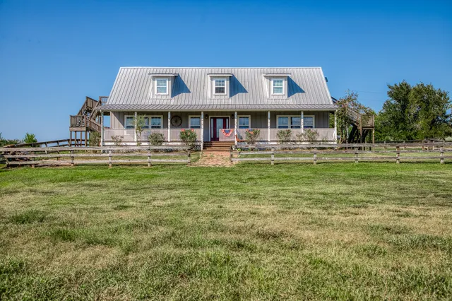 a front view of a building with a garden