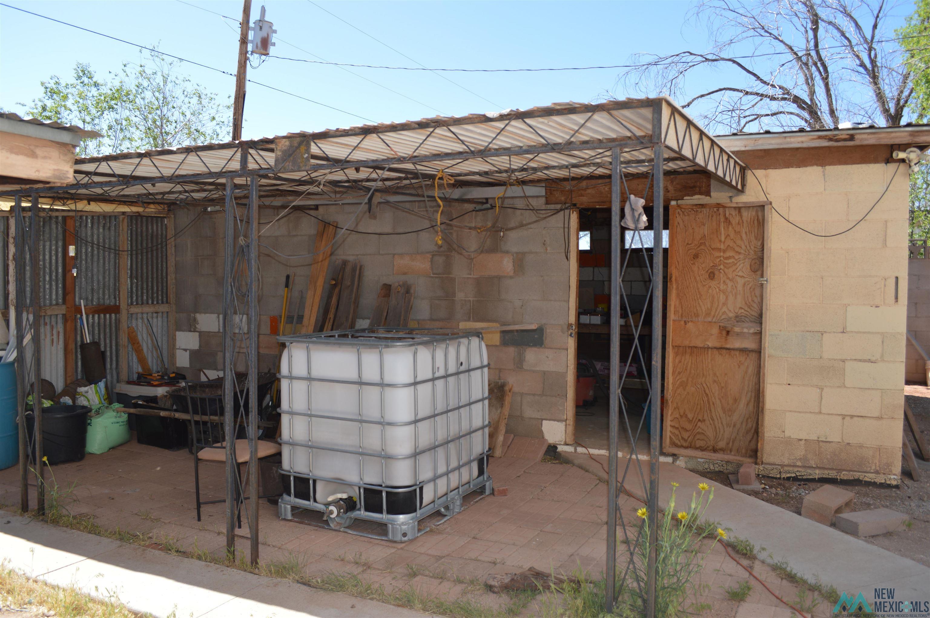 6 Sunny Dale Road Bluewater, NM 87005 - Photo 6 of 42 Outdoor covered patio area featuring a metal frame and corrugated roof