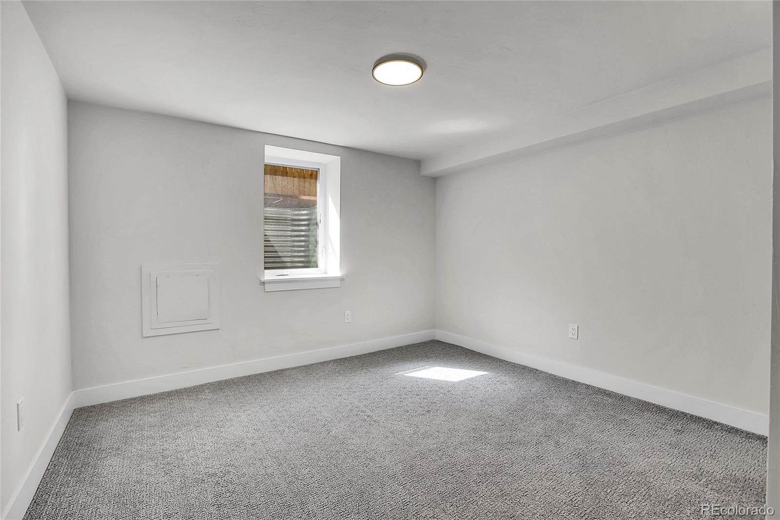 2827 Bellaire Street Denver, CO 80207 - Photo 25 of 31 an empty room with a window