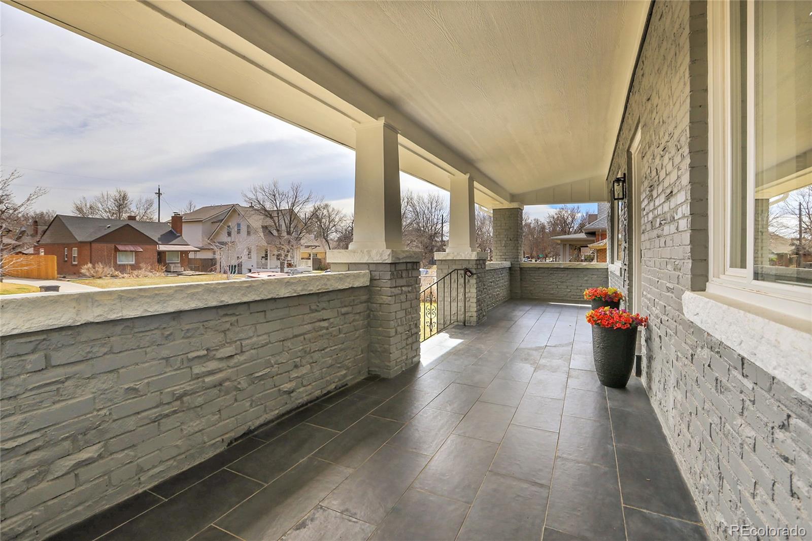 2827 Bellaire Street Denver, CO 80207 - Photo 3 of 31 a view of a porch with dining table and chairs