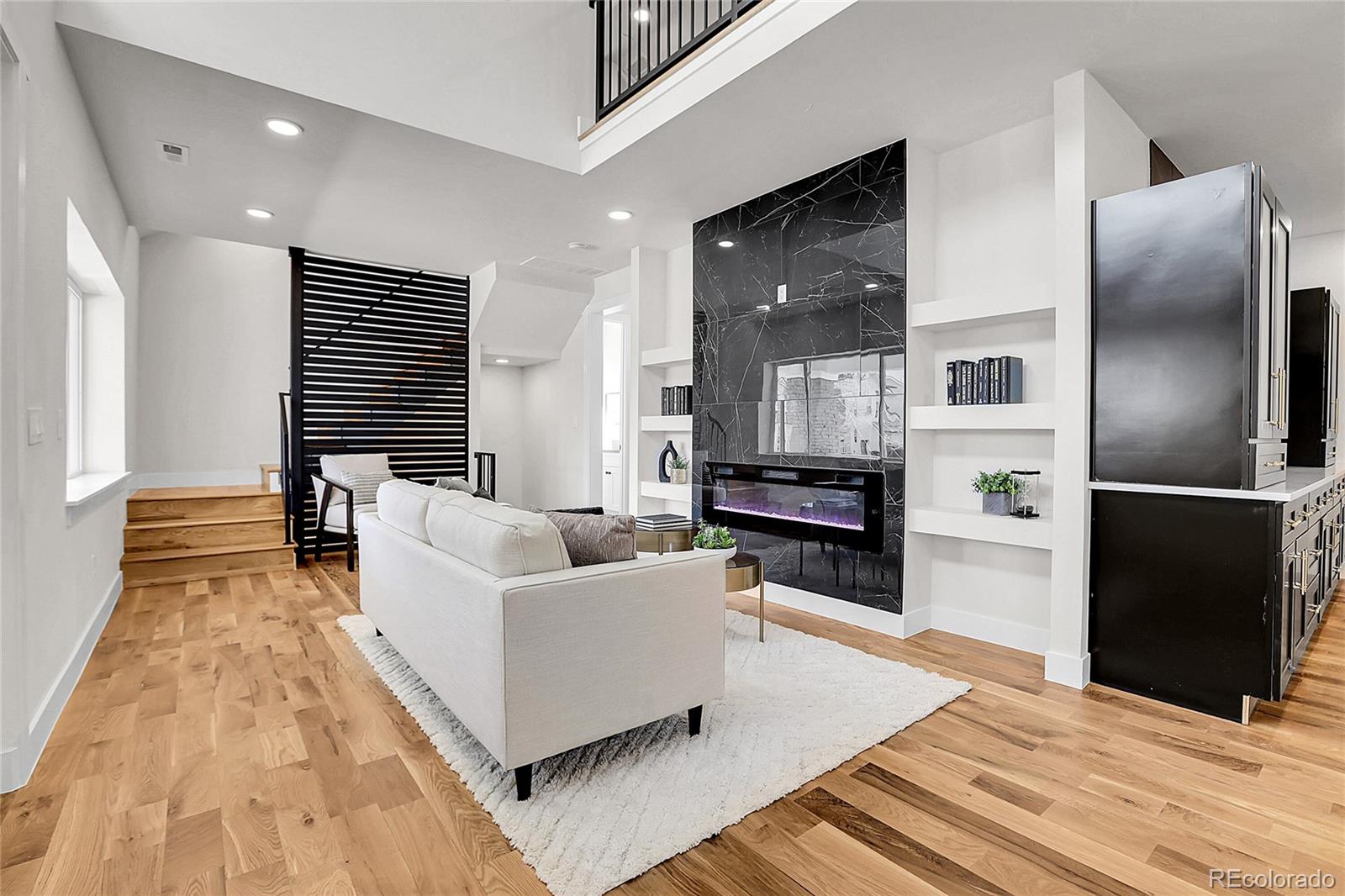 2827 Bellaire Street Denver, CO 80207 - Photo 9 of 31 a living room with furniture and a wooden floor
