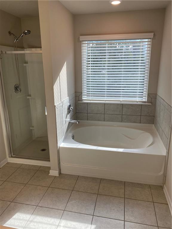 7055 Mimosa Bluff Lithonia, GA 30038 - Photo 11 of 17 a bathroom with a bathtub and a shower