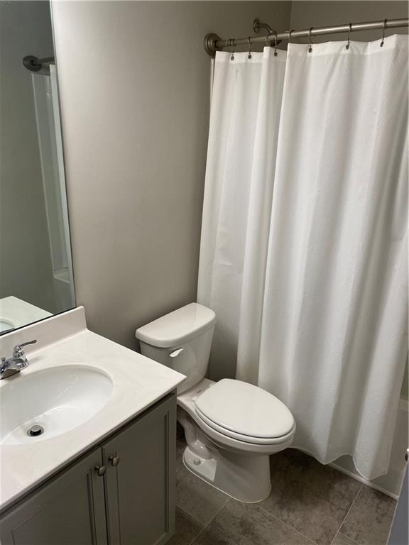 7055 Mimosa Bluff Lithonia, GA 30038 - Photo 15 of 17 a white toilet sitting next to a bathroom sink