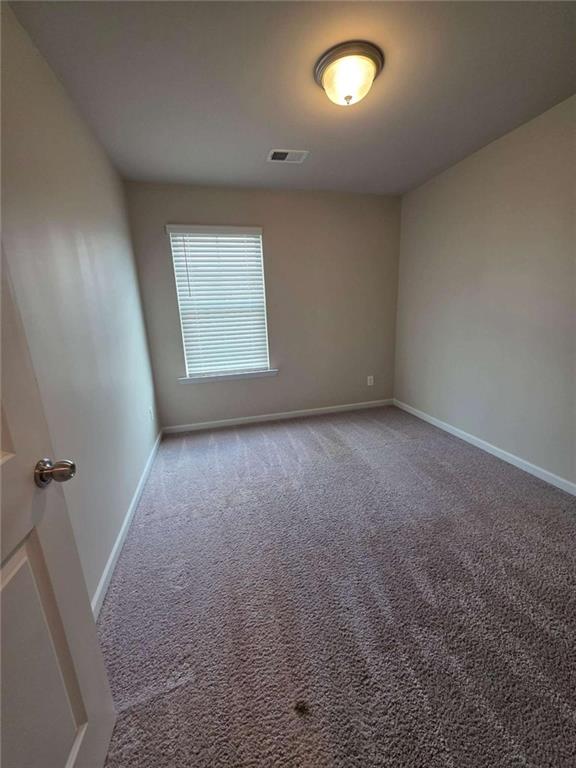 7055 Mimosa Bluff Lithonia, GA 30038 - Photo 16 of 17 an empty room with a empty space and a window