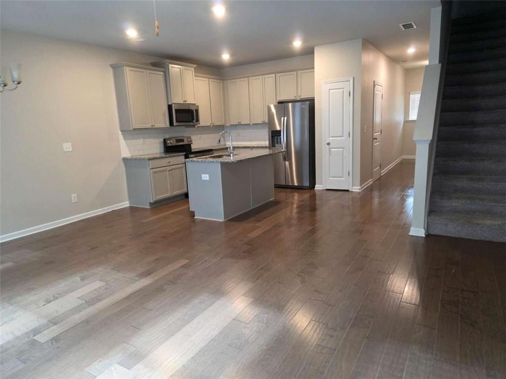 7055 Mimosa Bluff Lithonia, GA 30038 - Photo 2 of 17 a kitchen with stainless steel appliances a refrigerator sink and microwave