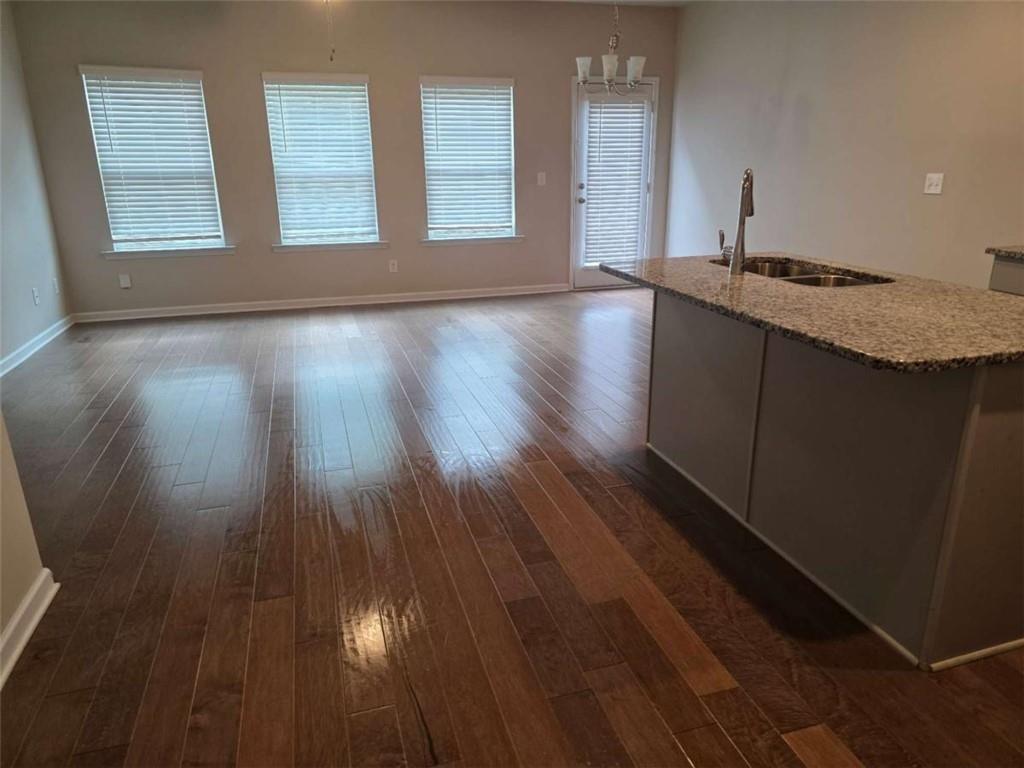7055 Mimosa Bluff Lithonia, GA 30038 - Photo 4 of 17 a view of an empty room with wooden floor and a window