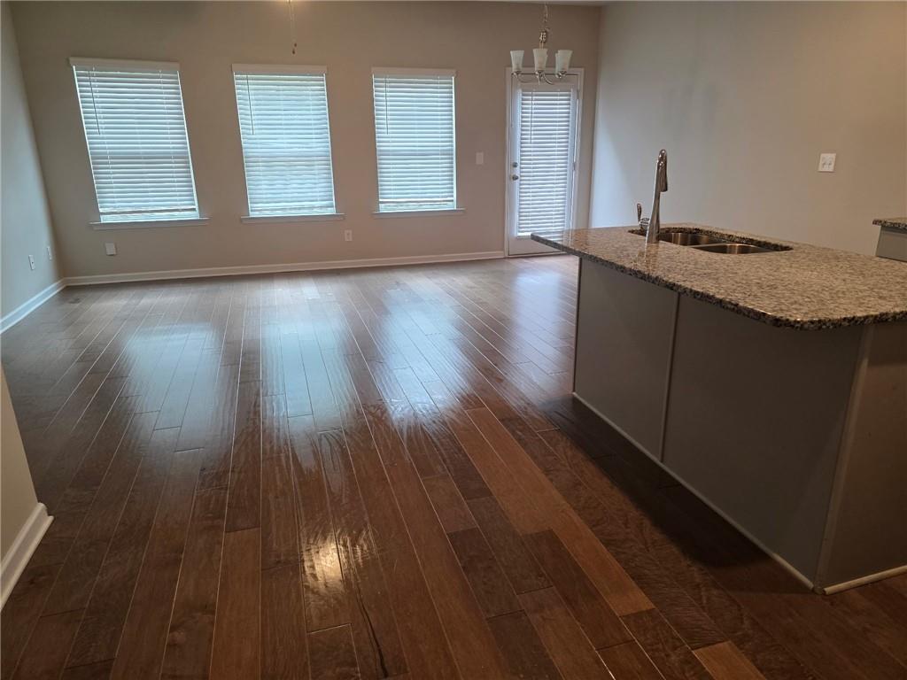 7055 Mimosa Bluff Lithonia, GA 30038 - Photo 5 of 17 a view of an empty room with wooden floor and a window
