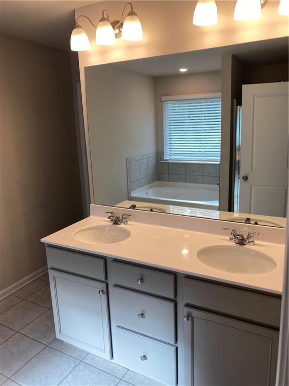 7055 Mimosa Bluff Lithonia, GA 30038 - Photo 10 of 17 a bathroom with a sink and a mirror