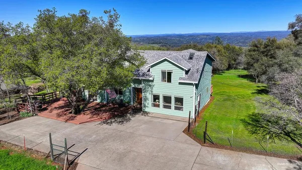 an aerial view of a house with a yard