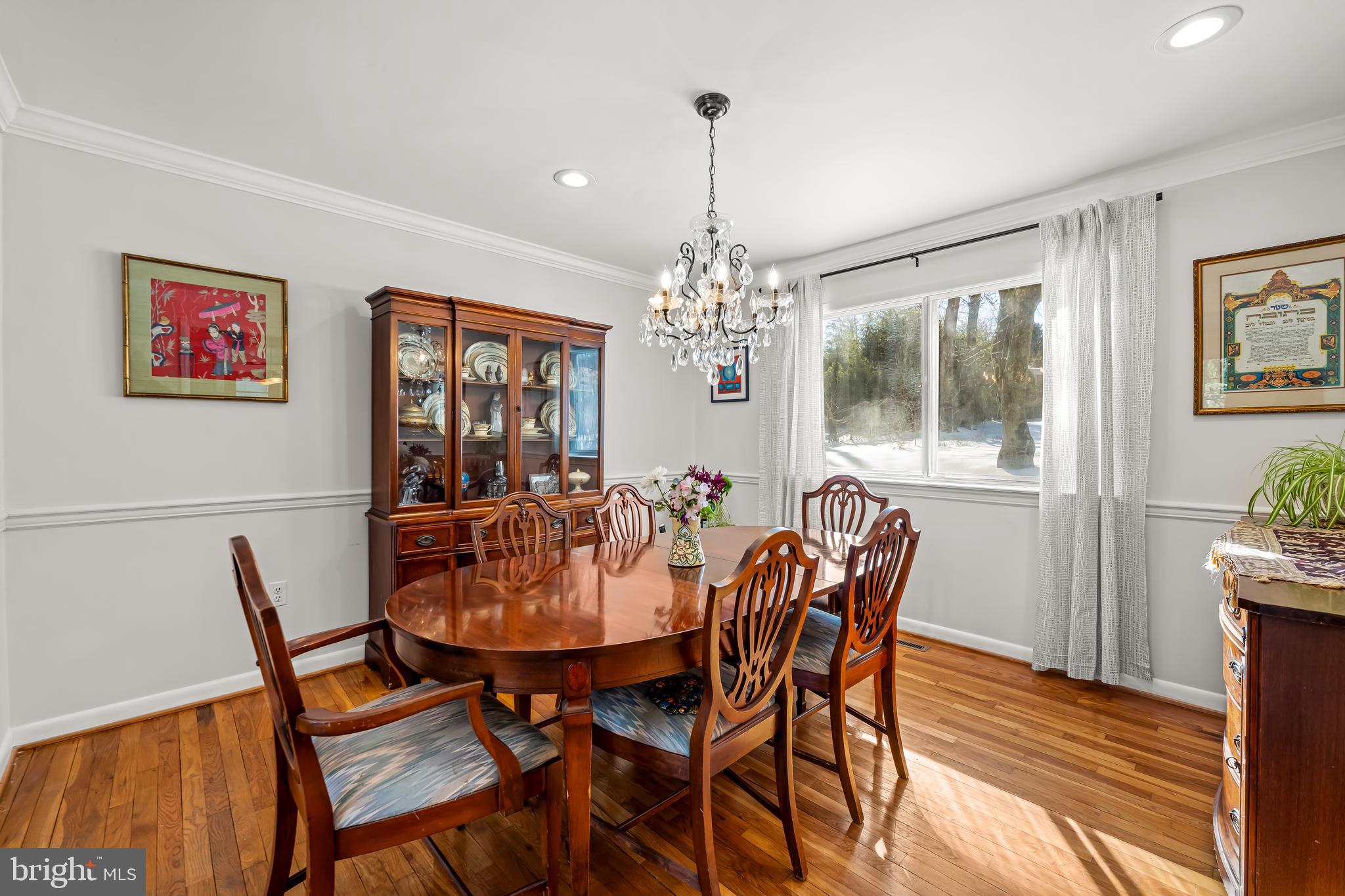 3407 Birch Hollow Road Baltimore, MD 21208 - Photo 11 of 47 a dining room with furniture a chandelier and wooden floor