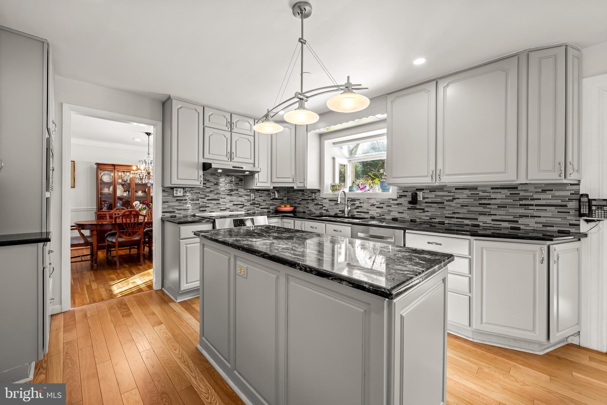 3407 Birch Hollow Road Baltimore, MD 21208 - Photo 13 of 47 a kitchen with granite countertop a sink cabinets and wooden floor