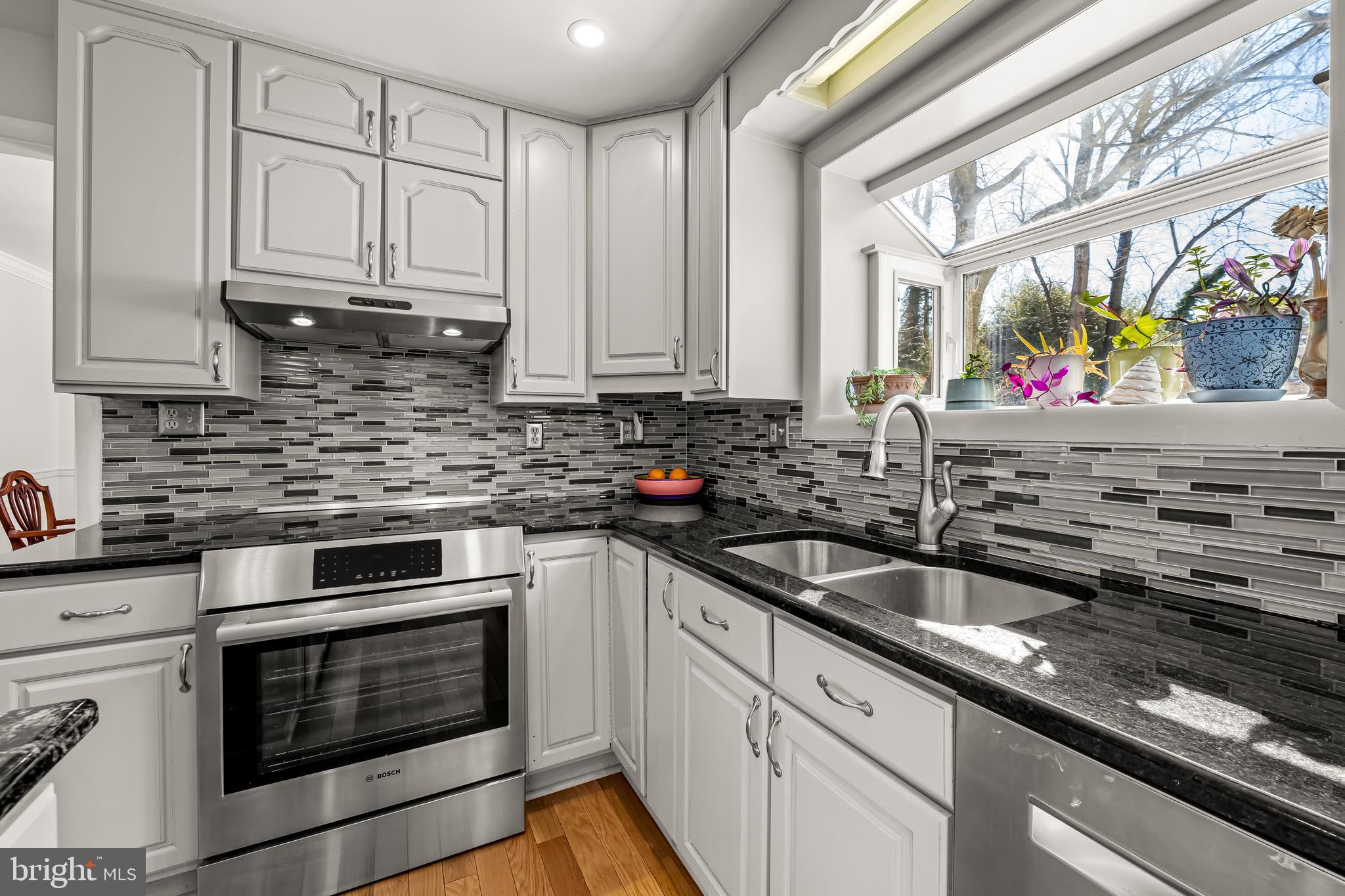 3407 Birch Hollow Road Baltimore, MD 21208 - Photo 17 of 47 a kitchen with stainless steel appliances granite countertop a sink stove and cabinets