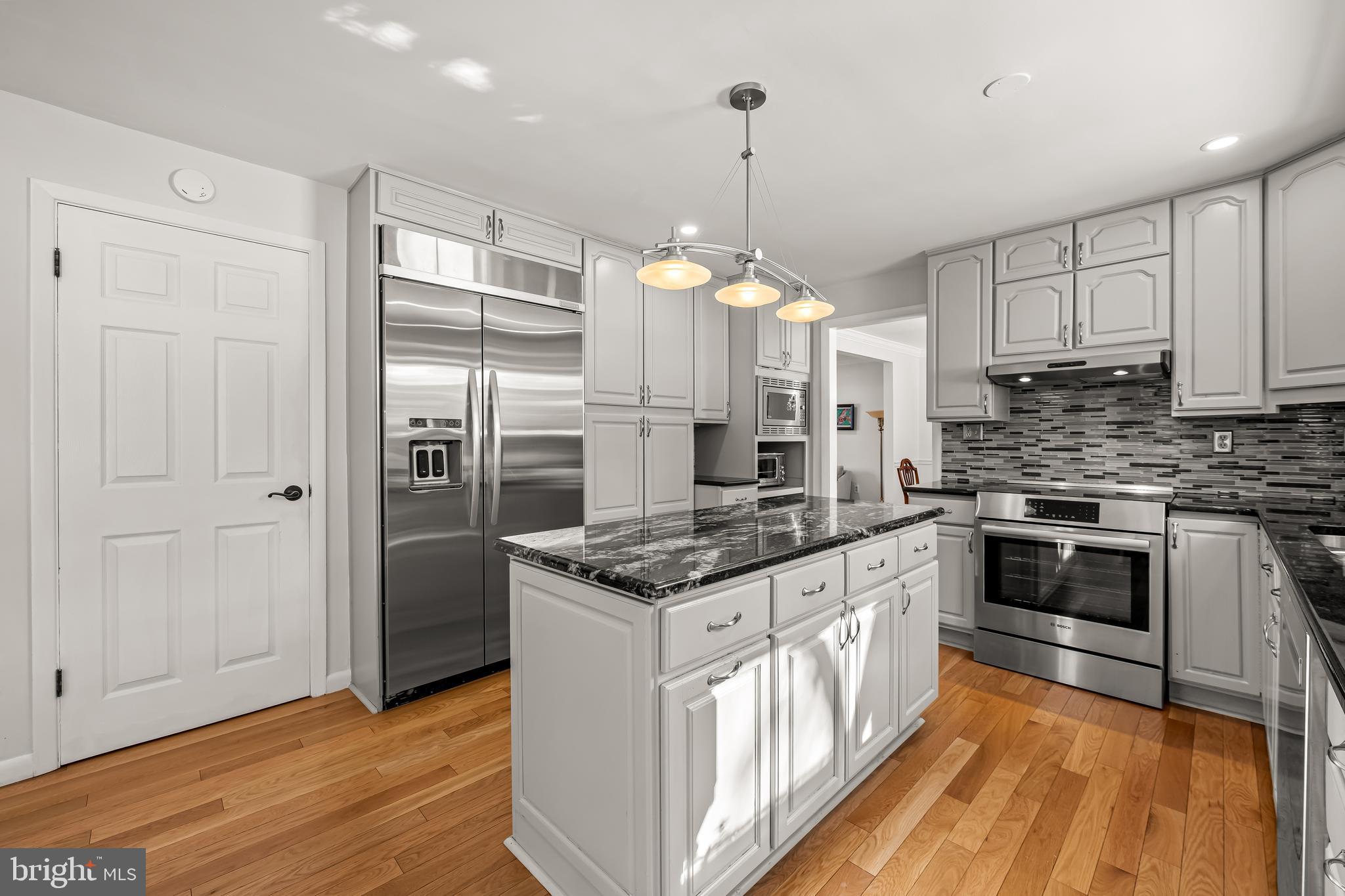 3407 Birch Hollow Road Baltimore, MD 21208 - Photo 18 of 47 a kitchen with stainless steel appliances granite countertop a stove and a sink