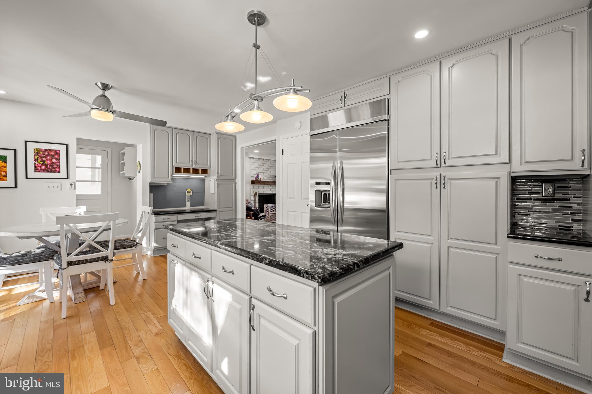 3407 Birch Hollow Road Baltimore, MD 21208 - Photo 19 of 47 a kitchen with stainless steel appliances granite countertop a sink a stove and a wooden floors