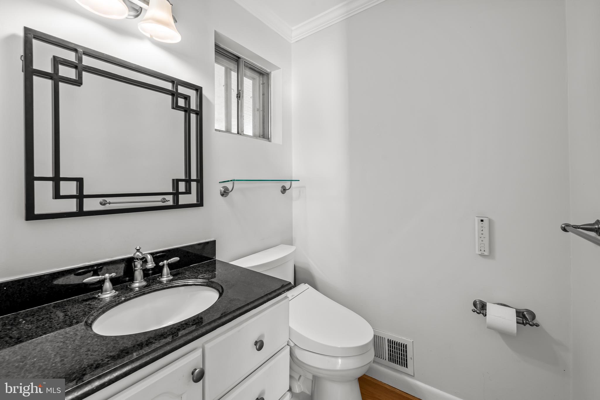 3407 Birch Hollow Road Baltimore, MD 21208 - Photo 25 of 47 a bathroom with a granite countertop sink mirror vanity and toilet