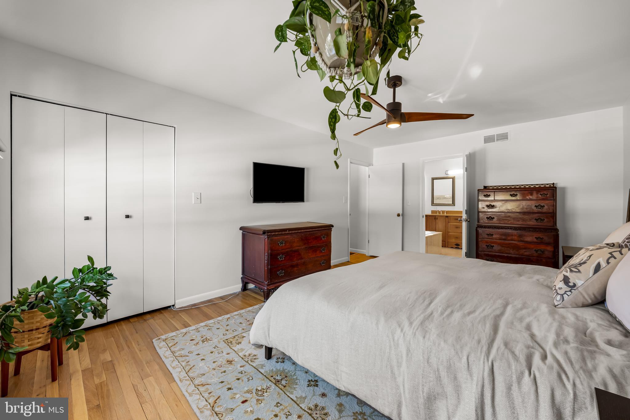 3407 Birch Hollow Road Baltimore, MD 21208 - Photo 30 of 47 a bedroom with a bed and a potted plant
