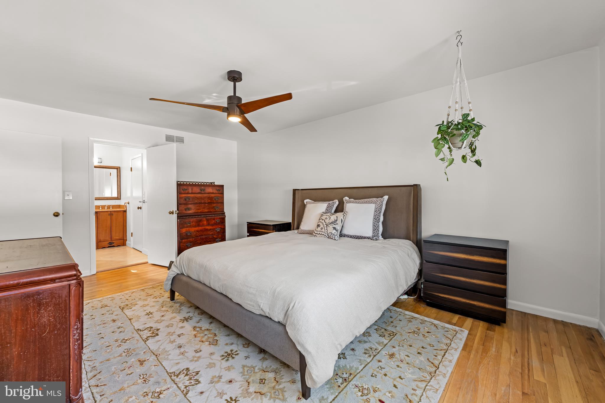 3407 Birch Hollow Road Baltimore, MD 21208 - Photo 31 of 47 a bedroom with a bed and a chandelier