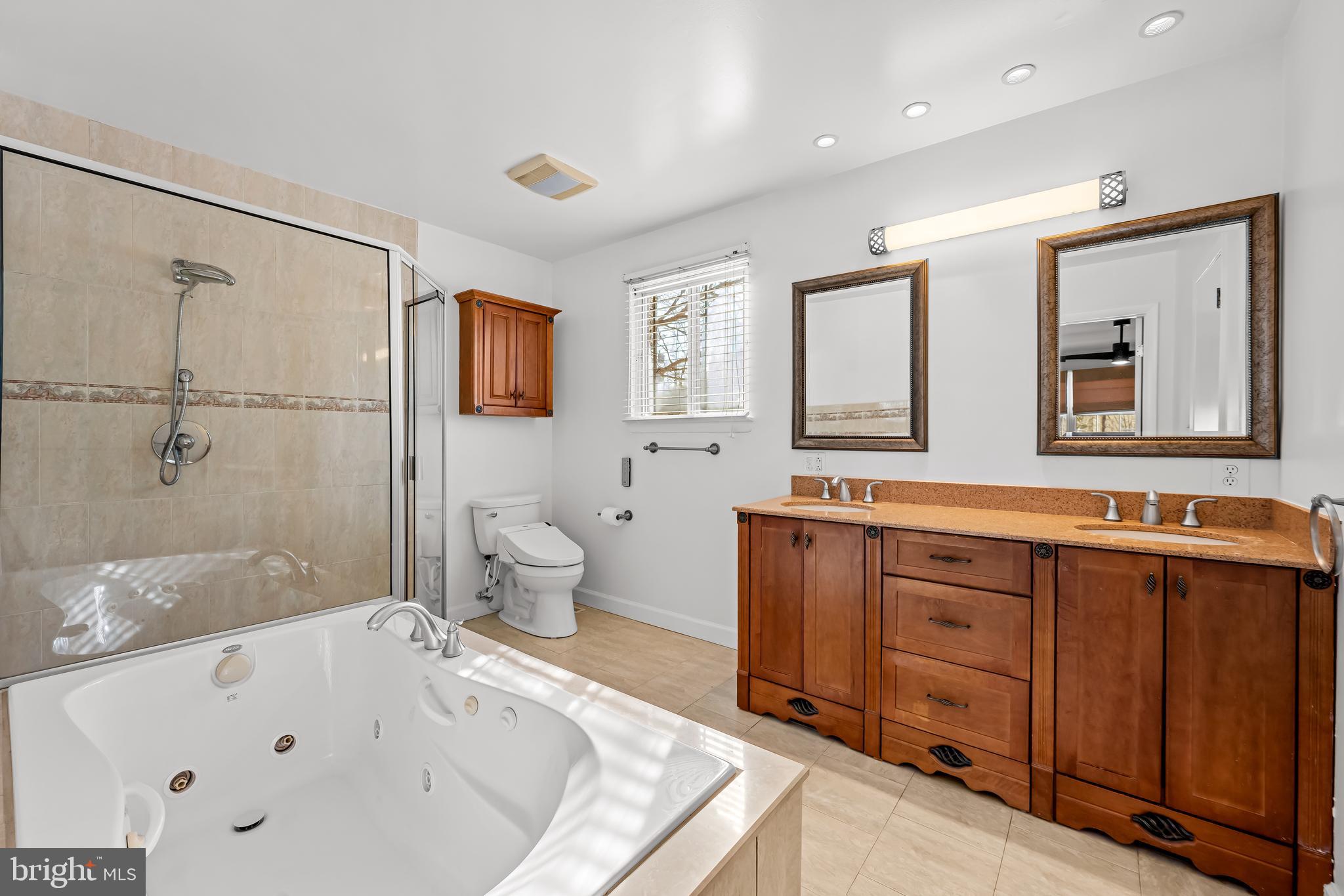 3407 Birch Hollow Road Baltimore, MD 21208 - Photo 32 of 47 a bathroom with a tub sink toilet and mirror